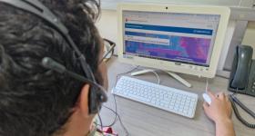 Persona frente a una computadora registrándose a cursos 